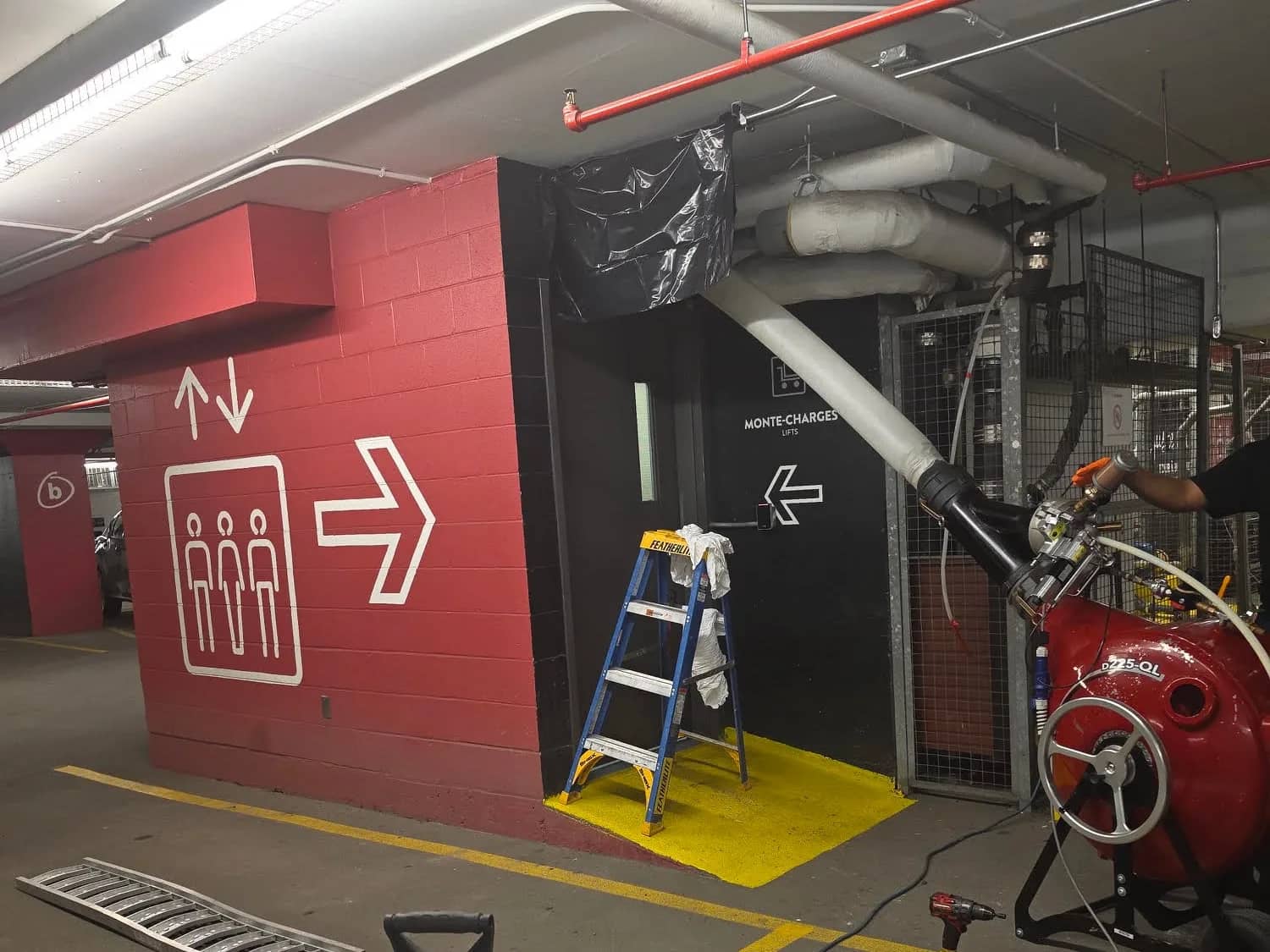 Liner routed from the inversion unit up to a ceiling pipe in an underground parking garage