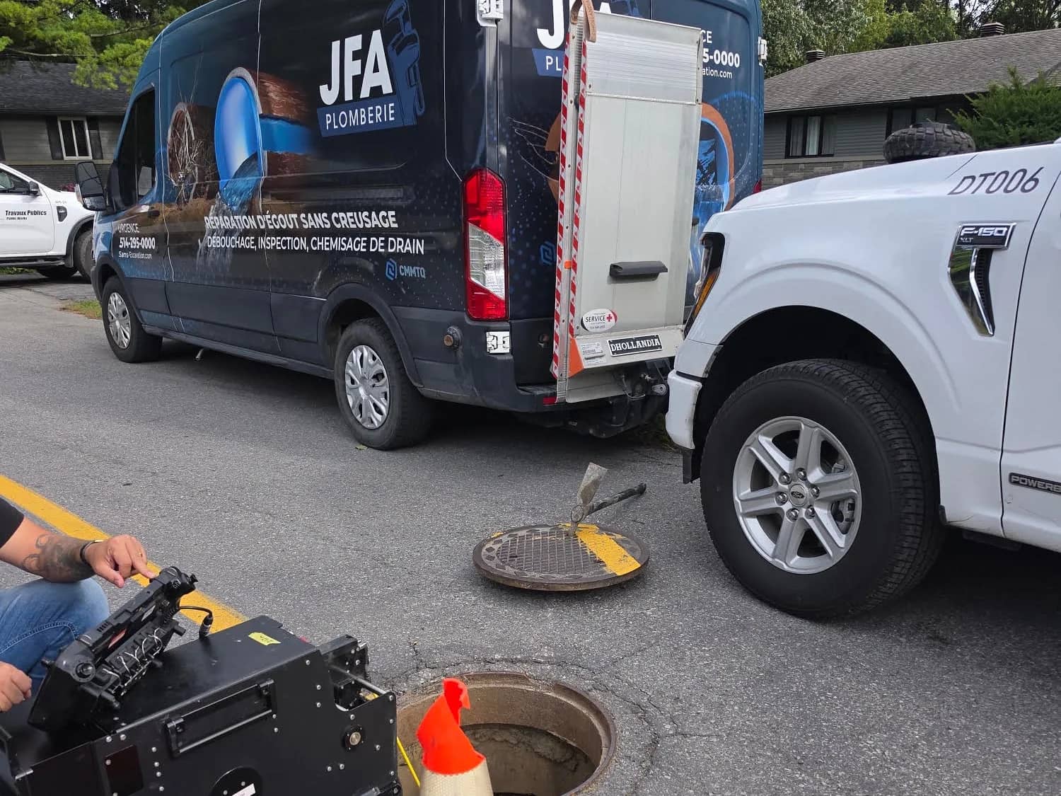 JFA Plomberie service van and inspection camera set up over an open sewer manhole